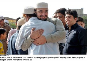 APP26-13 RAWALPINDI: September 13  Faithful exchanging Eid greeting after offering Eidul Azha prayers at Eidgah Sharif. APP photo by Abid Zia