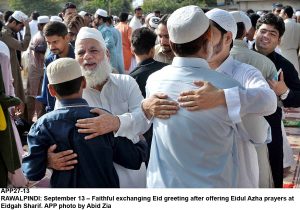 APP27-13 RAWALPINDI: September 13  Faithful exchanging Eid greeting after offering Eidul Azha prayers at Eidgah Sharif. APP photo by Abid Zia