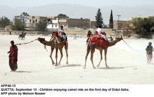 APP46-13 QUETTA: September 13 - Children enjoying camel ride on the first day of Eidul Azha. APP photo by Mohsin Naseer